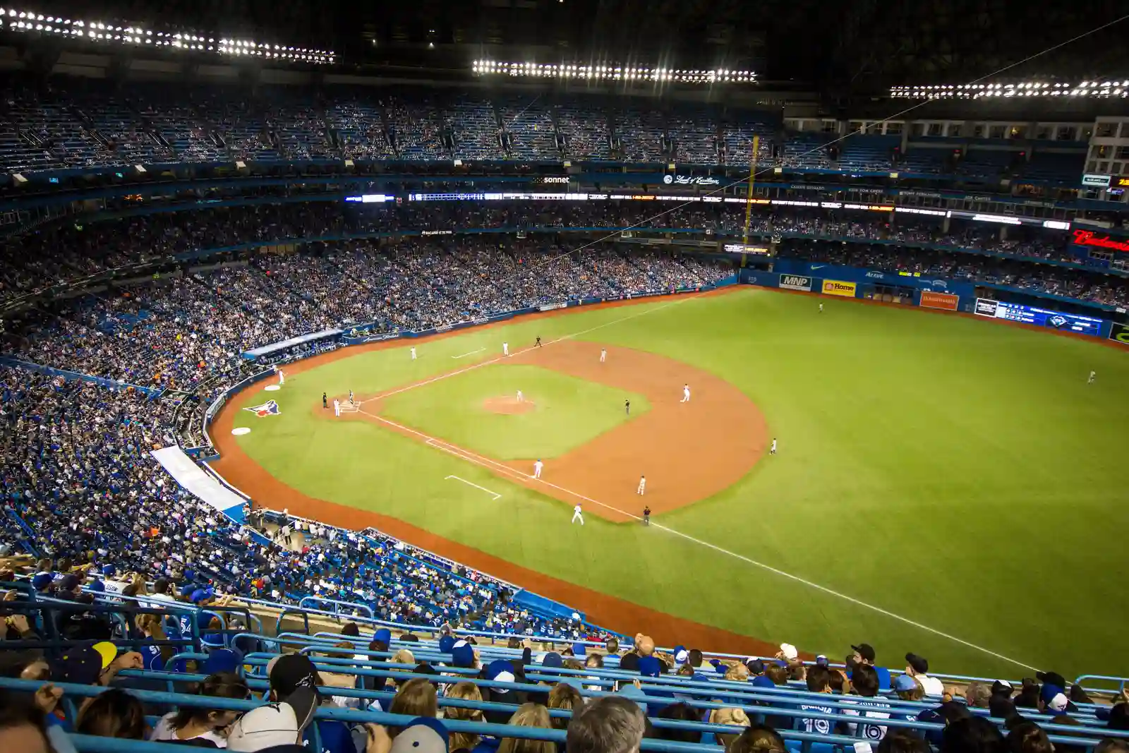 Packed MLB stadium during a night game, a reminder of how long is a baseball game from first pitch to last out