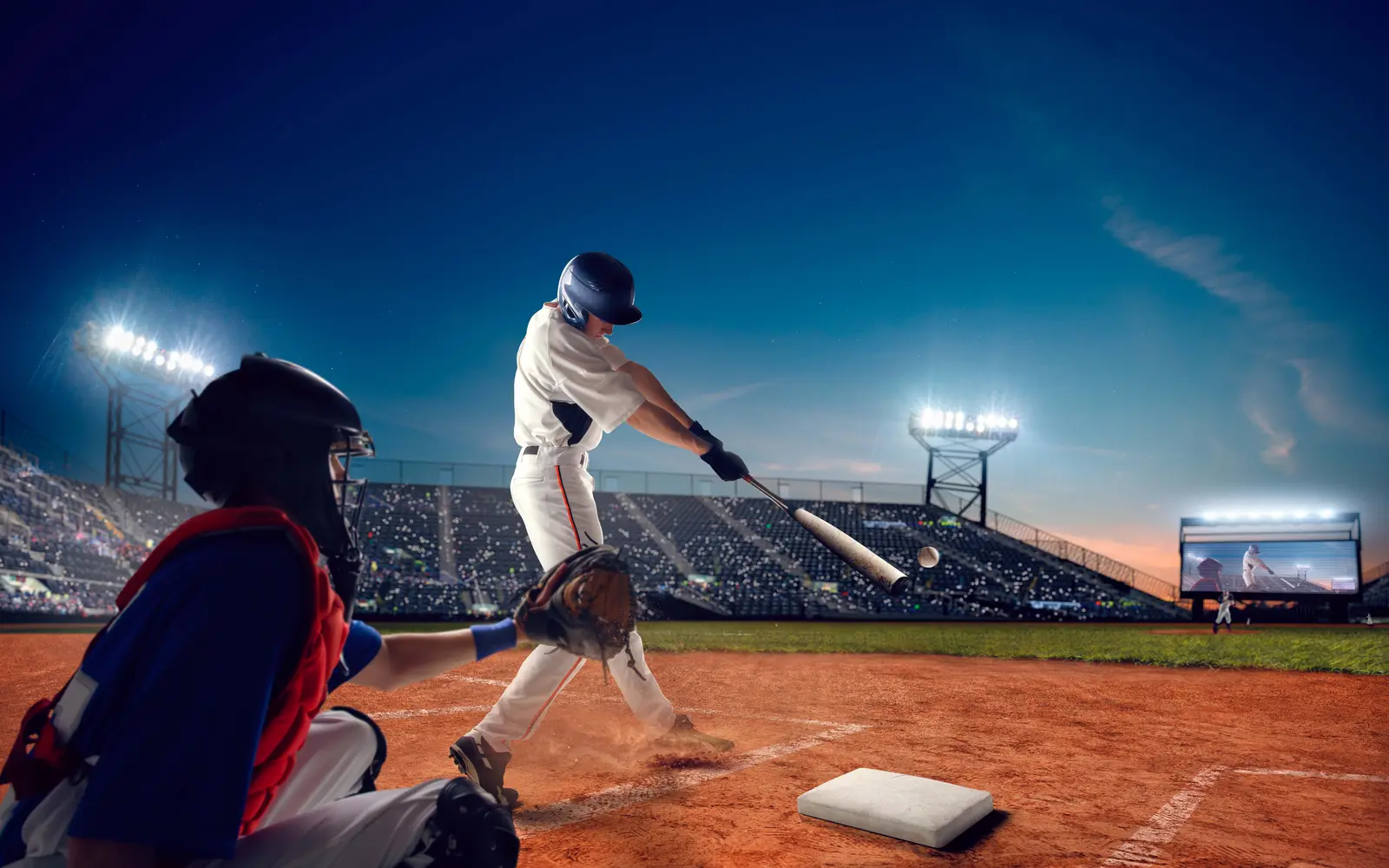 Batter driving the ball at night, showing what is OPS in baseball rewards with extra-base hits